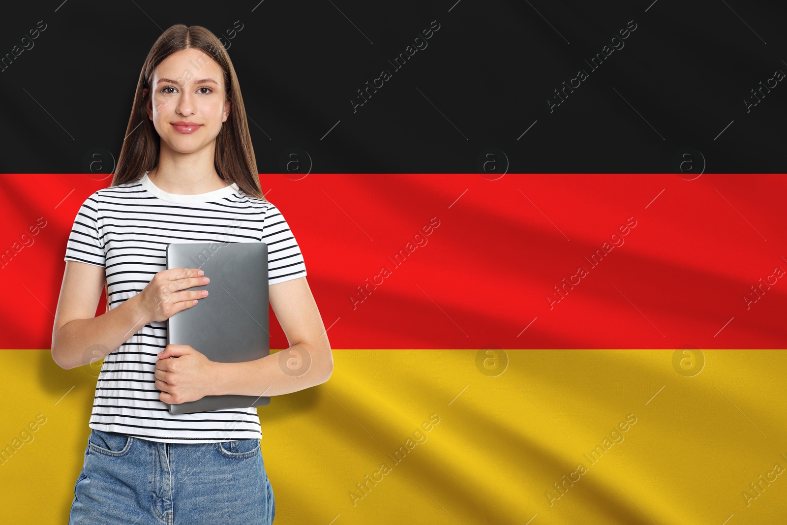 Image of Student with laptop against flag of Germany. Language school