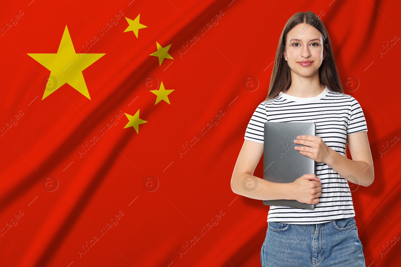 Image of Student with laptop against flag of China. Language school
