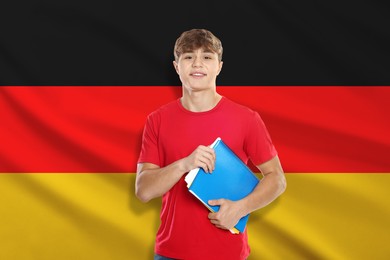 Image of Student with notebooks against flag of Germany. Language school