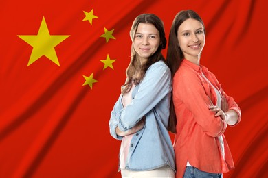 Image of Happy students against flag of China. Language school