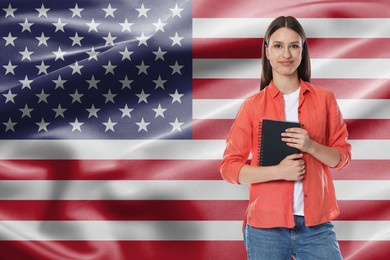 Image of Student with notebook against flag of USA. Language school