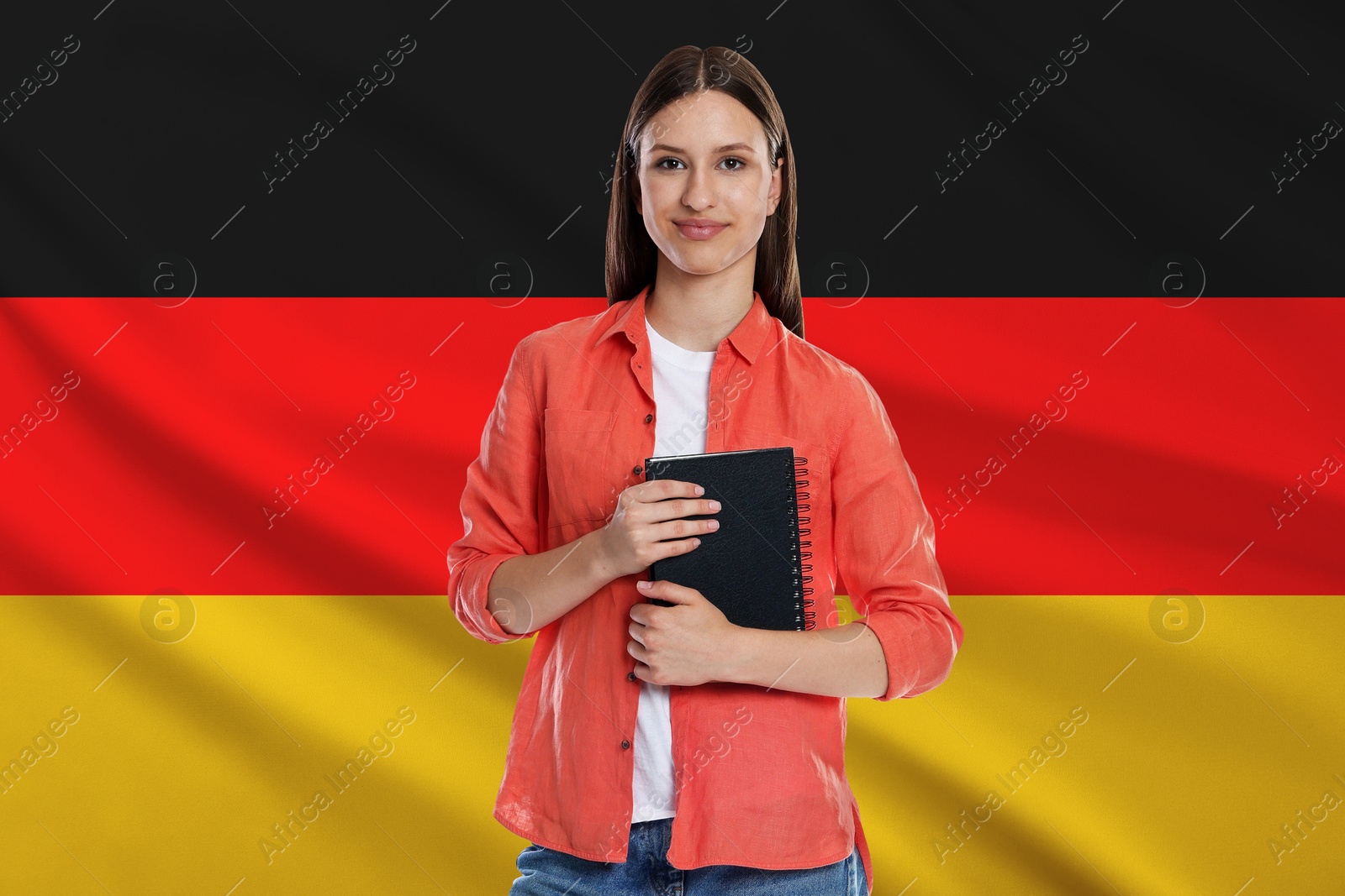 Image of Student with notebook against flag of Germany. Language school