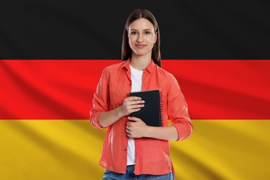 Image of Student with notebook against flag of Germany. Language school