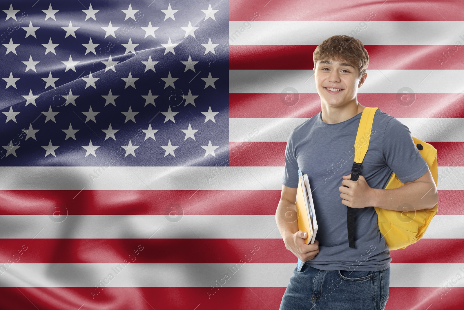Image of Student with notebooks and backpack against flag of USA. Language school