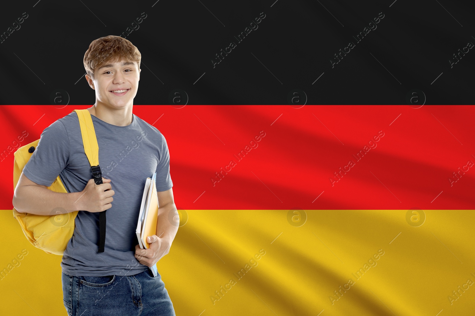 Image of Student with notebooks and backpack against flag of Germany. Language school