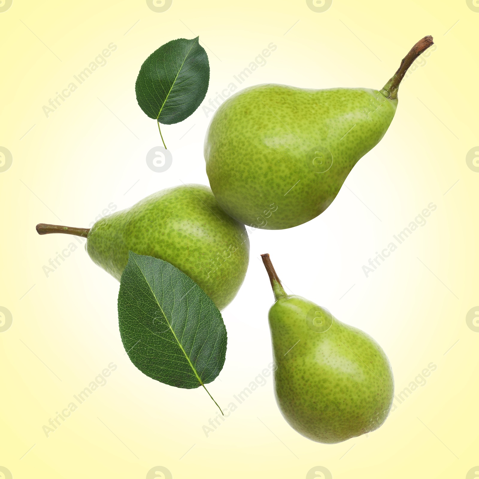Image of Fresh green pears flying in air on light yellow background