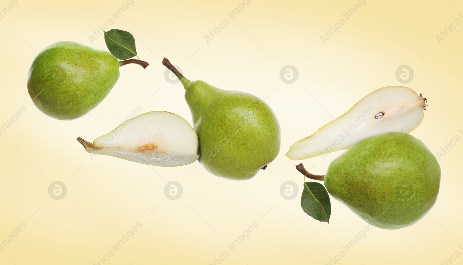Image of Fresh green pears flying in air on pale orange background