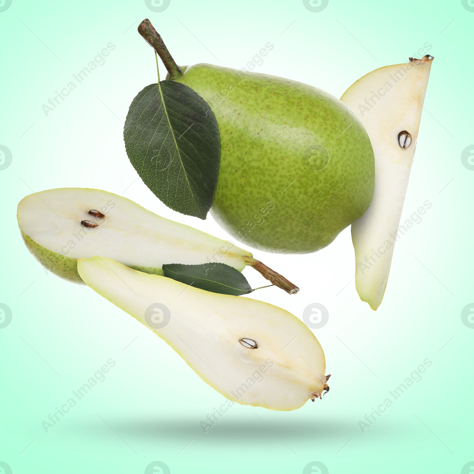 Image of Fresh green pears flying in air on turquoise background