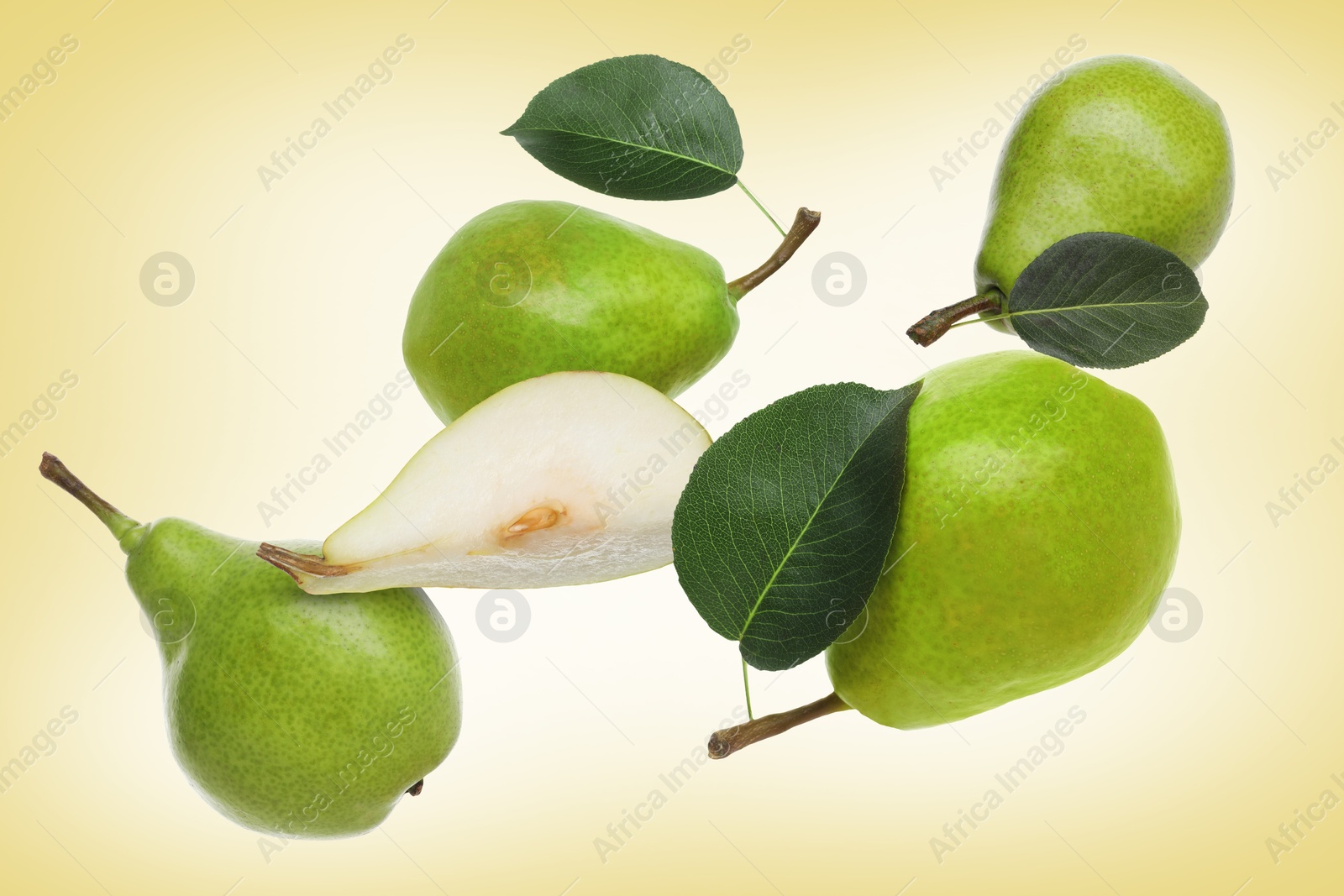Image of Fresh green pears flying in air on pale orange background