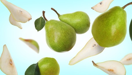 Image of Fresh green pears flying in air on light blue background