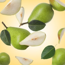 Image of Fresh green pears flying in air on pale orange background