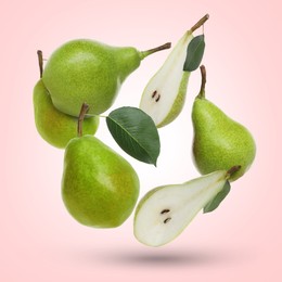 Image of Fresh green pears flying in air on pink background