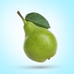 Image of Fresh green pear flying in air on light blue background
