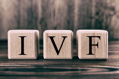 Image of In vitro fertilization. Cubes with abbreviation IVF on wooden table