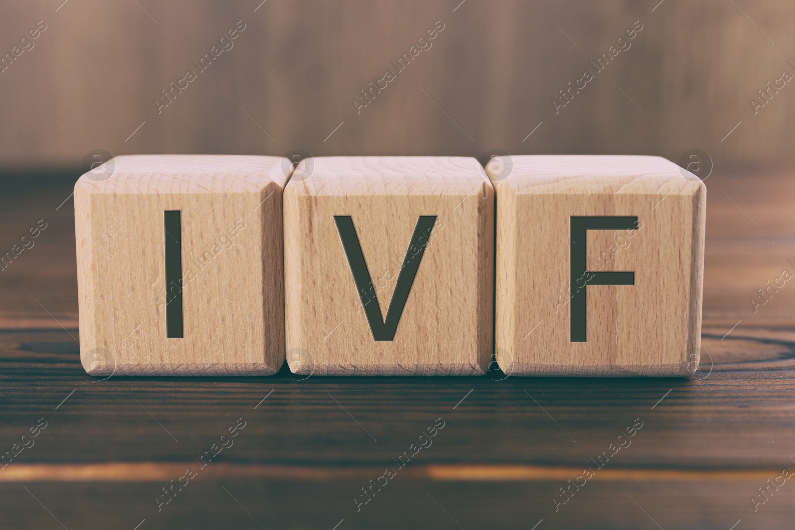 Image of In vitro fertilization. Cubes with abbreviation IVF on wooden table