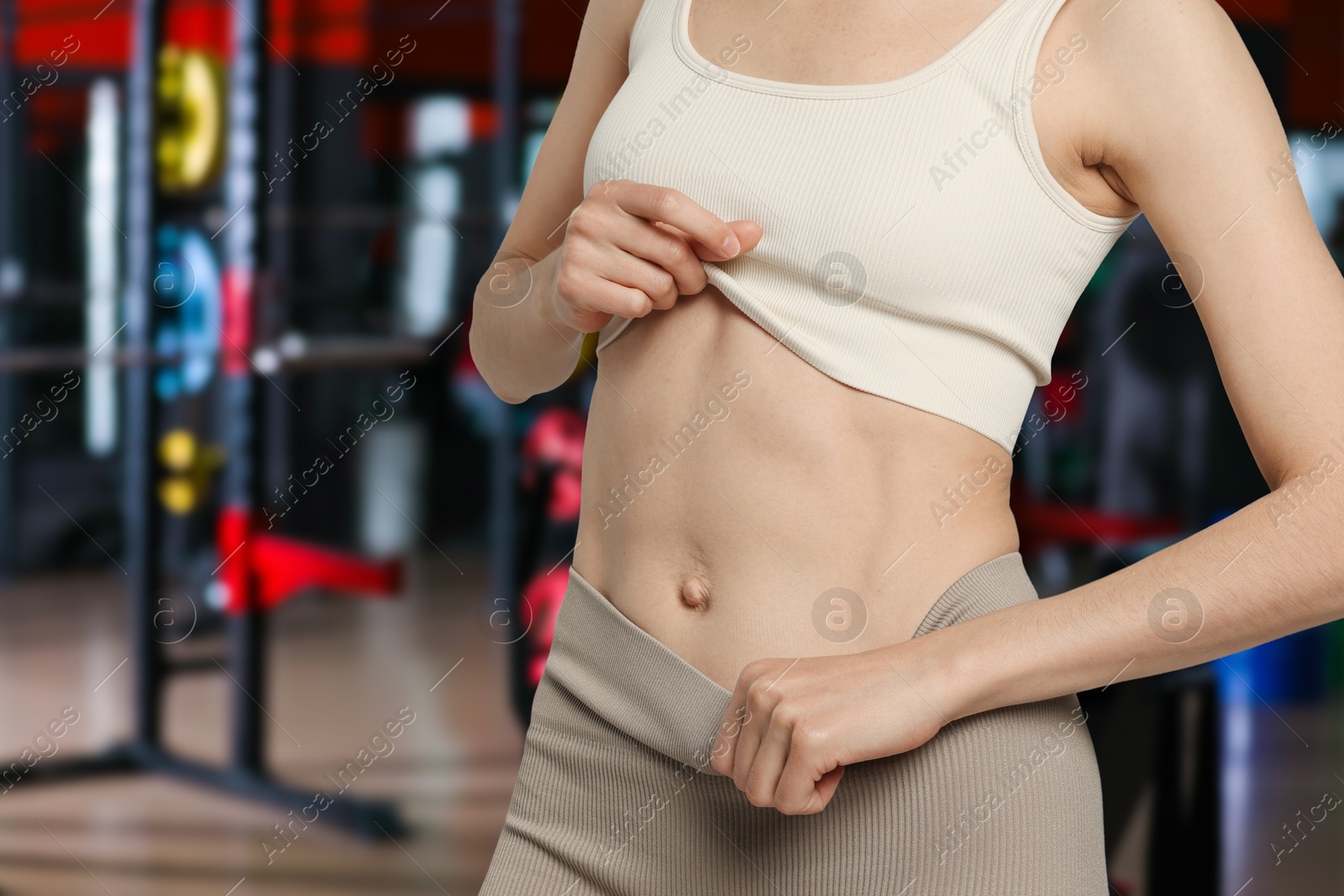 Image of Athletic woman with flat belly in gym, closeup