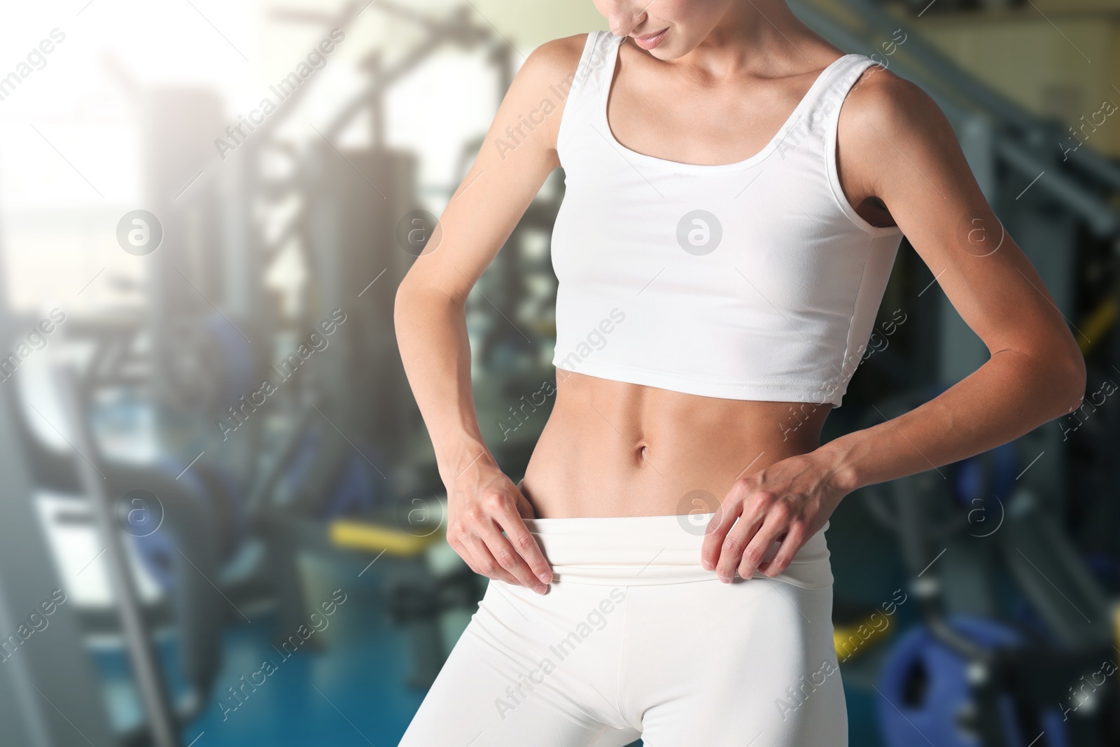 Image of Athletic woman with flat belly in gym, closeup