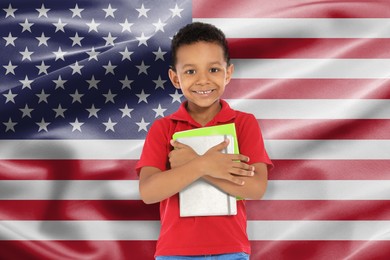 Image of Little boy with notebooks against flag of USA. Language school