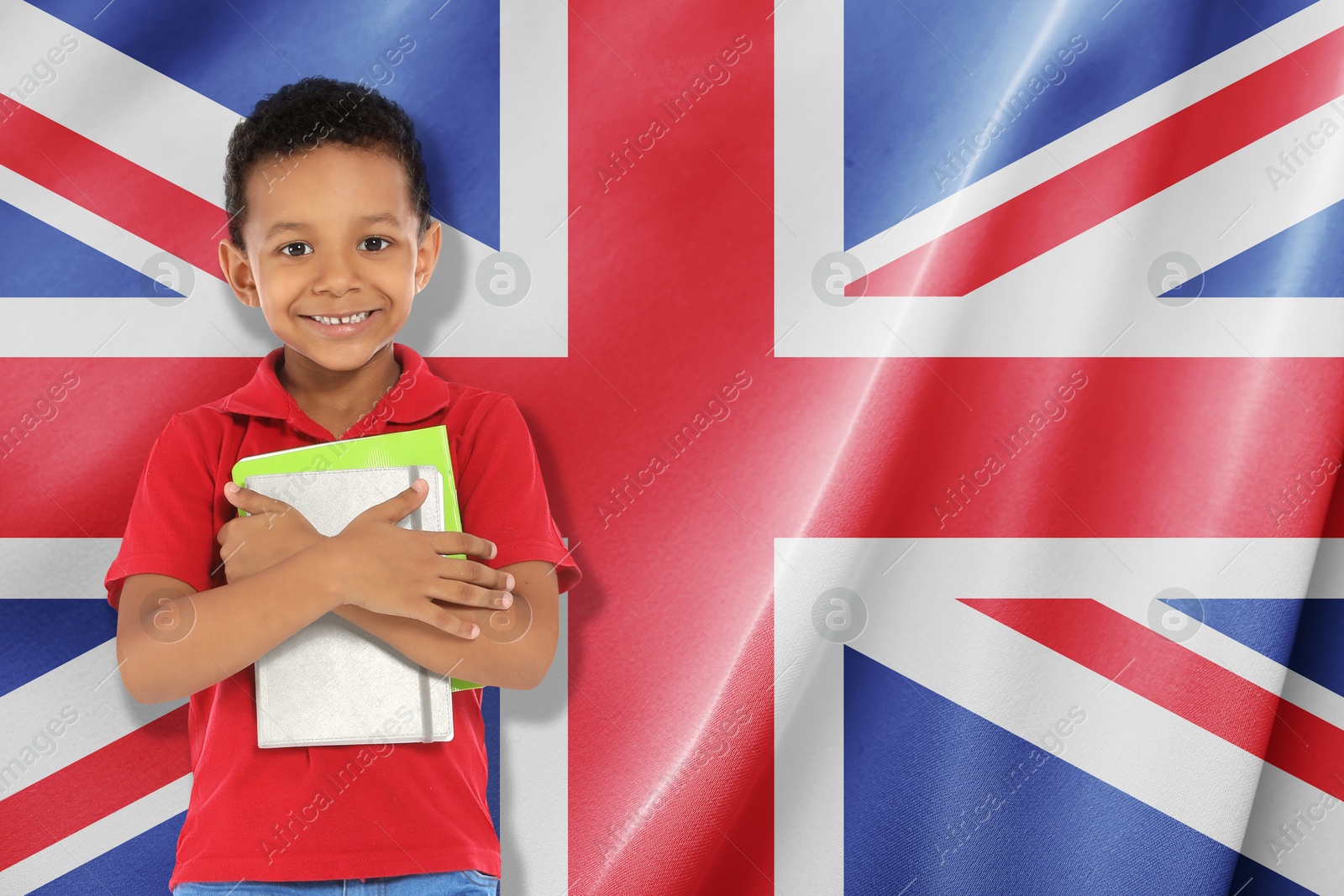 Image of Little boy with notebooks against flag of United Kingdom. Language school