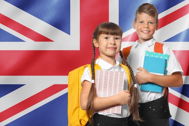 Image of Children with backpacks and notebooks against flag of United Kingdom. Language school