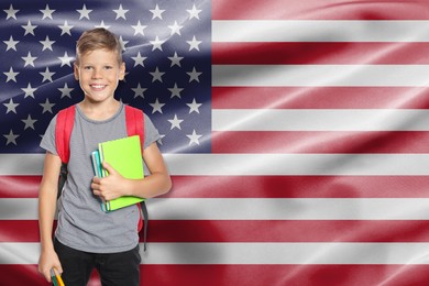 Image of Little boy with backpack and stationery against flag of USA. Language school