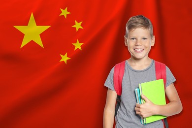 Image of Little boy with backpack against flag of China. Language school