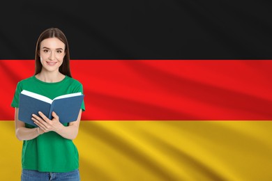 Image of Student or teacher with book against flag of Germany. Language school
