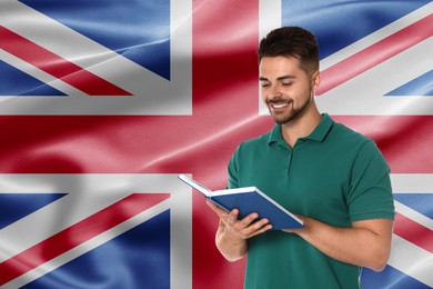 Image of Student or teacher with book against flag of United Kingdom. Language school