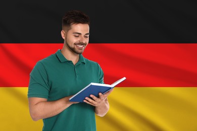 Image of Student or teacher with book against flag of Germany. Language school