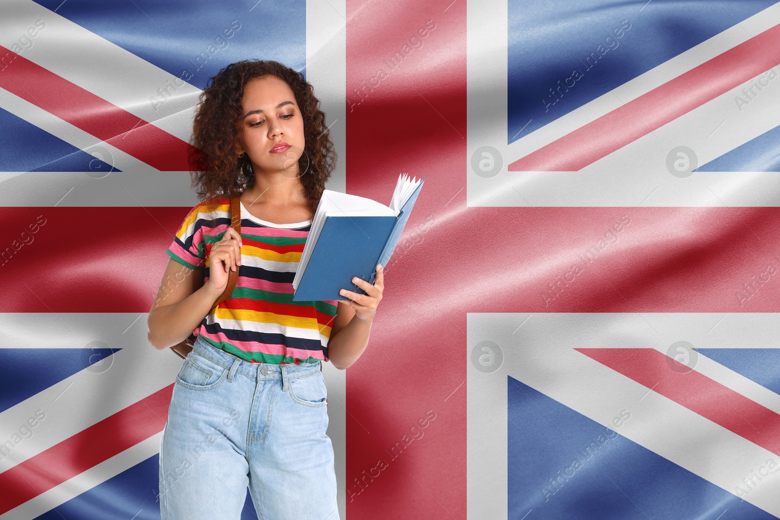 Image of Student with book against flag of United Kingdom. Language school