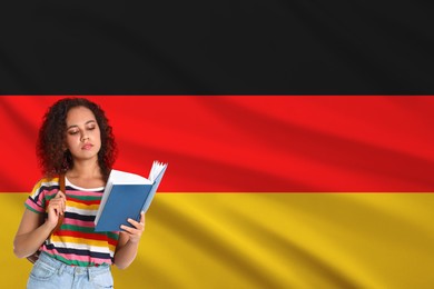 Image of Student with book against flag of Germany. Language school
