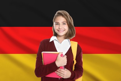Image of Student with backpack and notebooks against flag of Germany. Language school