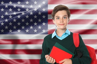 Image of Student with backpack and notebooks against flag of USA. Language school