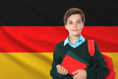 Image of Student with backpack and notebooks against flag of Germany. Language school