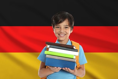 Image of Little boy with books against flag of Germany. Language school