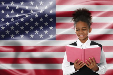 Image of Little girl with book against flag of USA. Language school