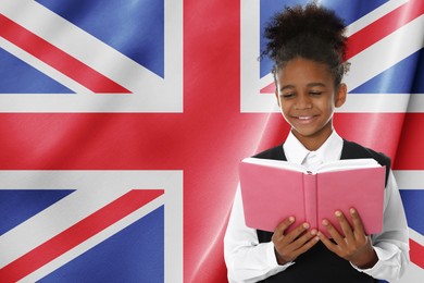 Image of Little girl with book against flag of United Kingdom. Language school