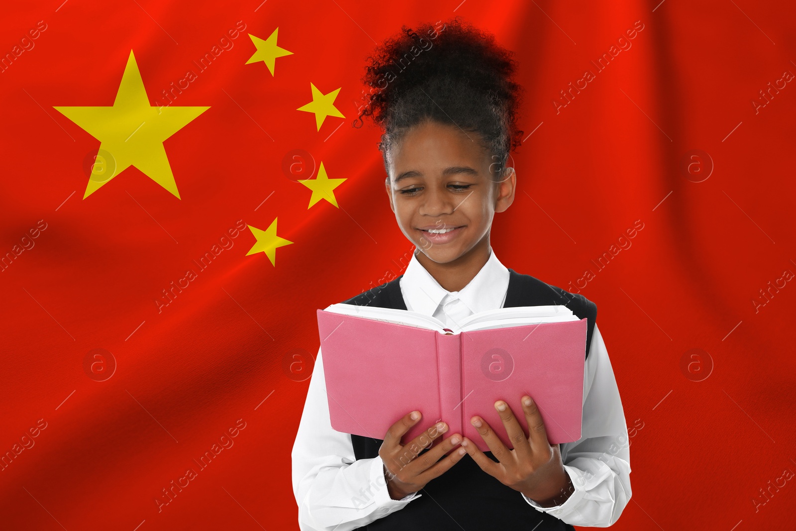Image of Little girl with book against flag of China. Language school