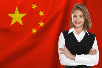 Image of Happy student against flag of China. Language school