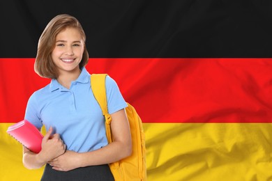 Image of Happy student with backpack and notebook against flag of Germany. Language school