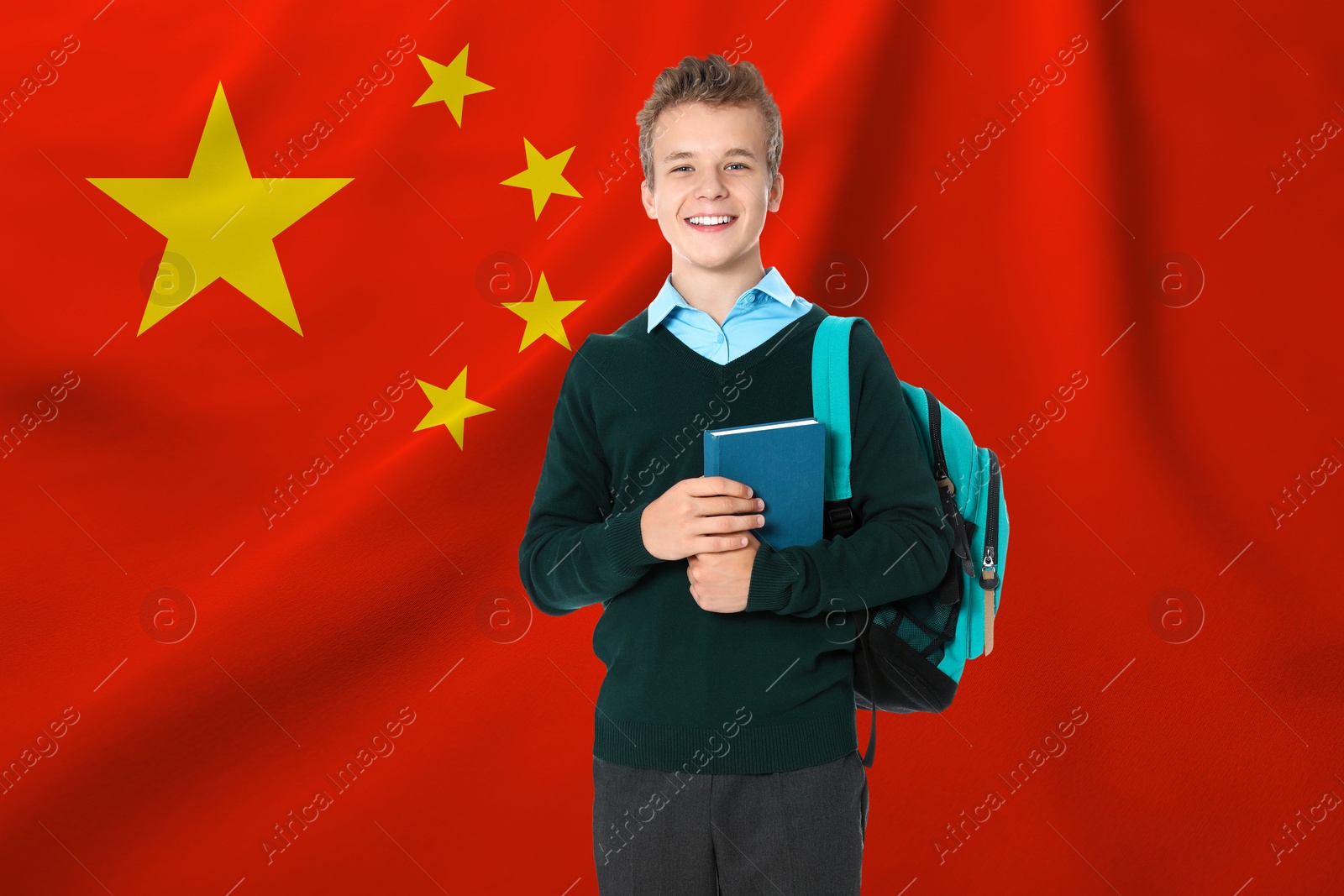 Image of Happy student with backpack and book against flag of China. Language school