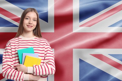 Image of Student with notebooks against flag of United Kingdom. Language school