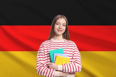 Image of Student with notebooks against flag of Germany. Language school