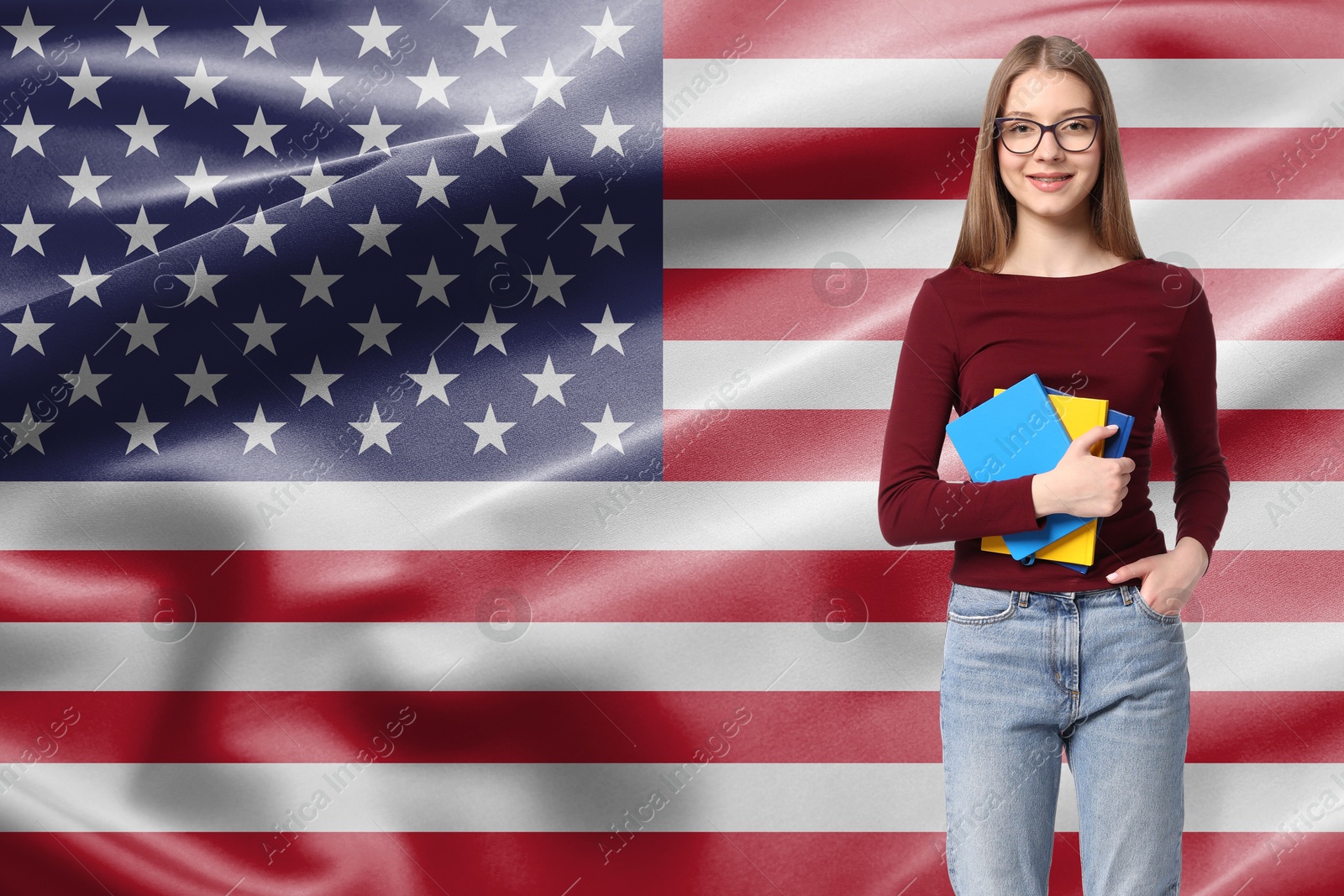 Image of Student with eyeglasses and notebooks against flag of USA. Language school