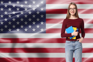 Image of Student with eyeglasses and notebooks against flag of USA. Language school