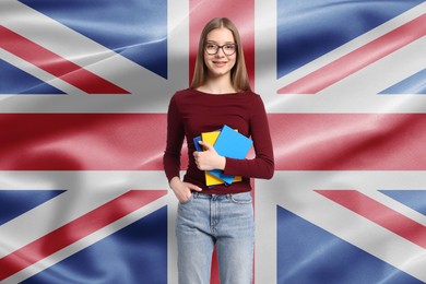 Image of Student with eyeglasses and notebooks against flag of United Kingdom. Language school