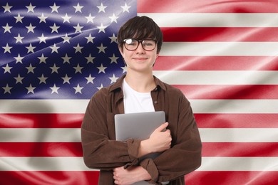 Image of Student with eyeglasses and laptop against flag of USA. Language school