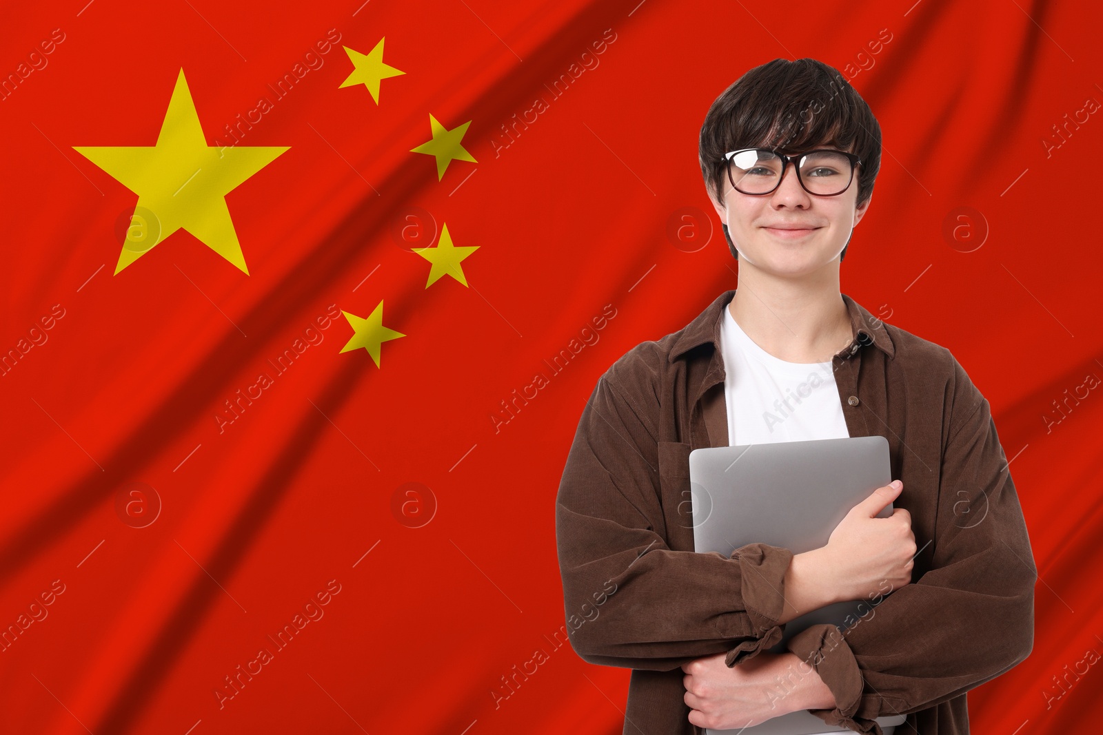 Image of Student with eyeglasses and laptop against flag of China. Language school