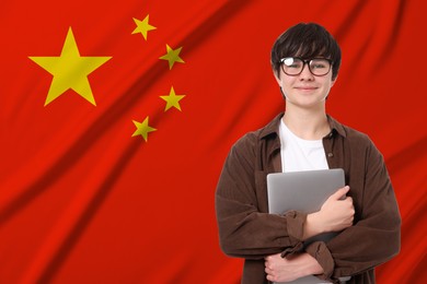 Image of Student with eyeglasses and laptop against flag of China. Language school