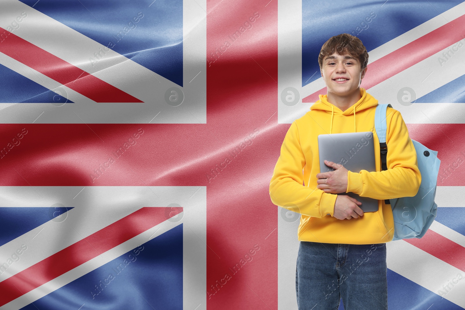 Image of Student with laptop and backpack against flag of United Kingdom. Language school